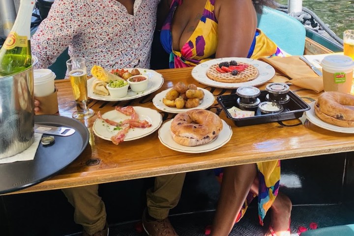 a woman sitting at a table with a plate of food