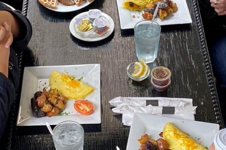 a person sitting at a table with a plate of food