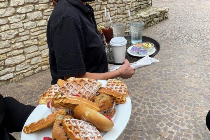 a person sitting at a table eating food