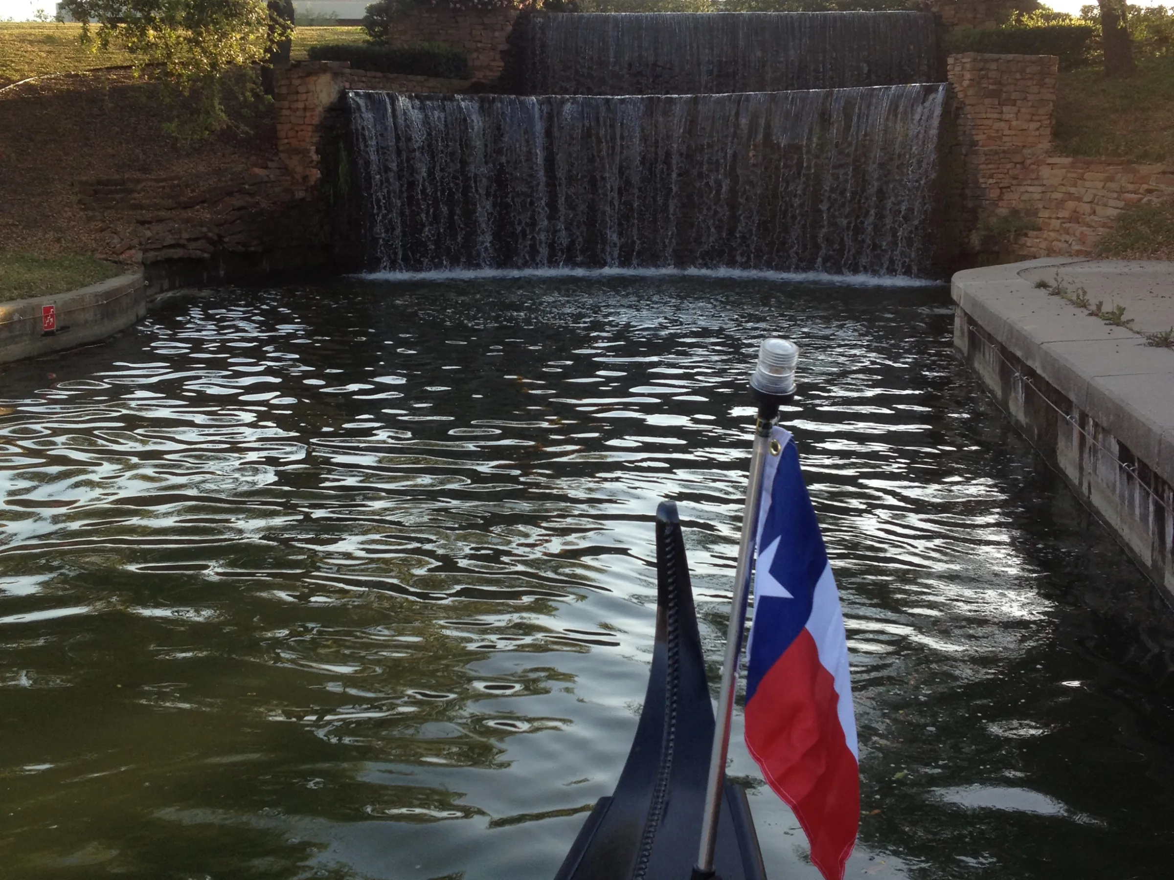 texas flag on gondola near waterfall