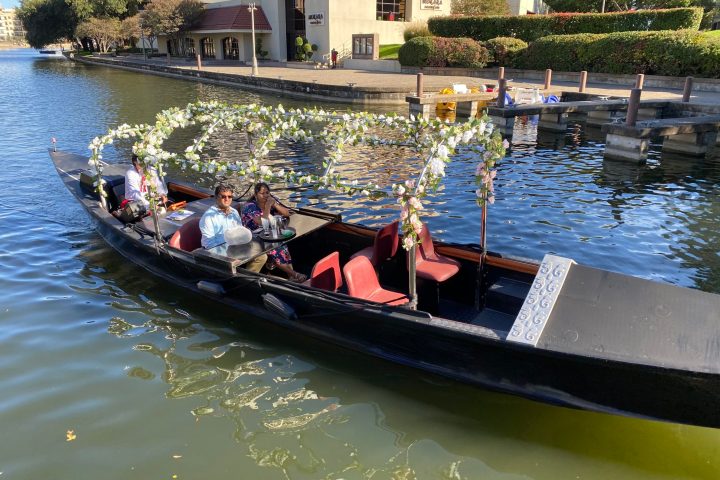 a group of people in a small boat in a body of water