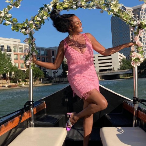 a woman riding on the back of a boat