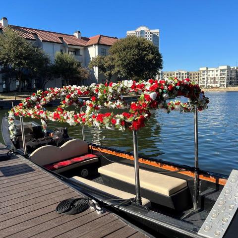 a row of parked motorcycles sitting next to a body of water