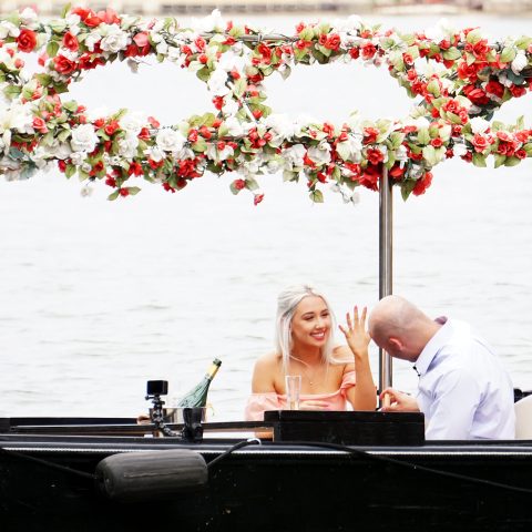 a person sitting in a boat on a body of water