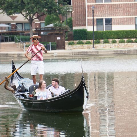 a man riding on the back of a boat in the water