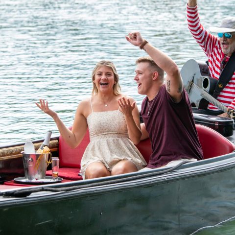 a group of people in a boat on a body of water