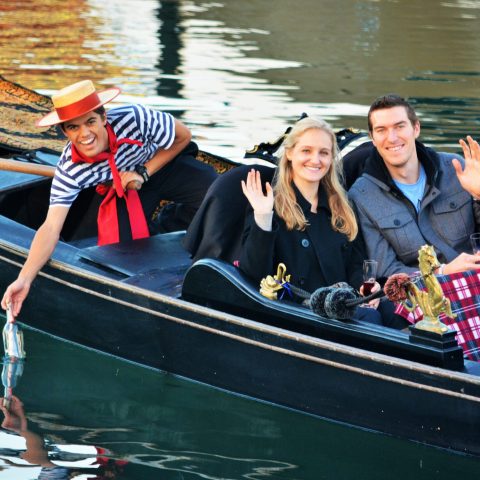 a group of people in a boat on a body of water