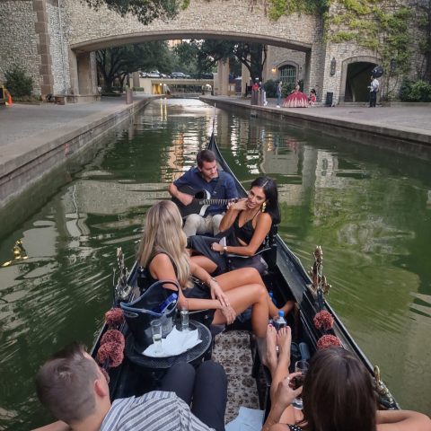 a group of people sitting on a boat in the water